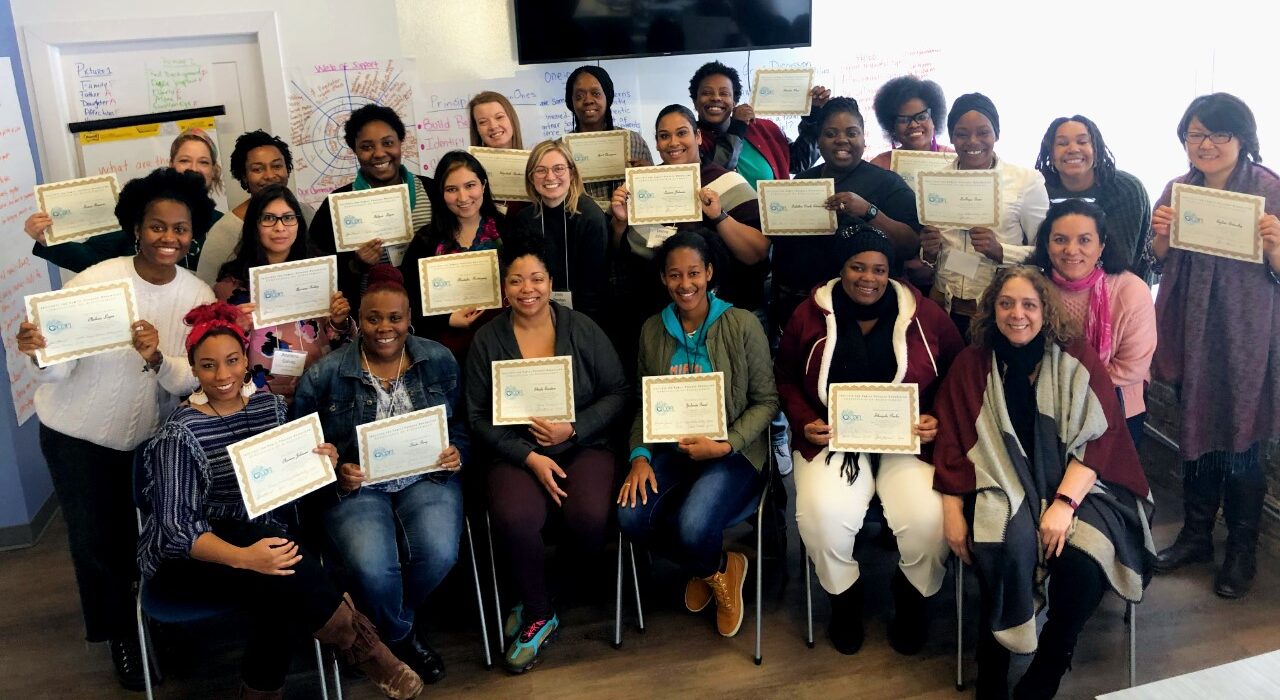 A group of women holding certificates pose for a photo at the end of their training