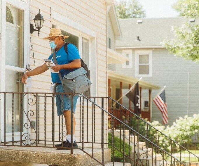 A man doorknocking and doing outreach