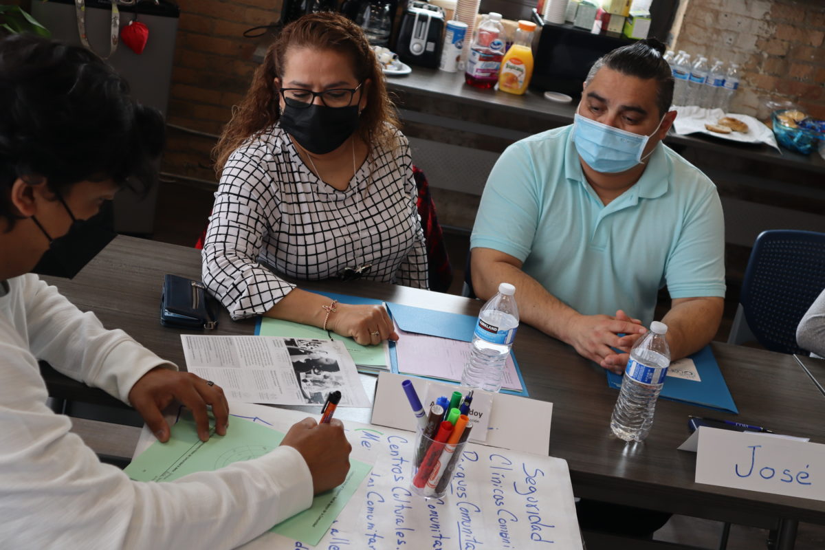 Three workshop participants work on an assignment together