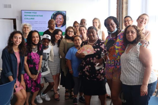 A group of about 17 people, mostly Black and Latina women, standing for a picture together