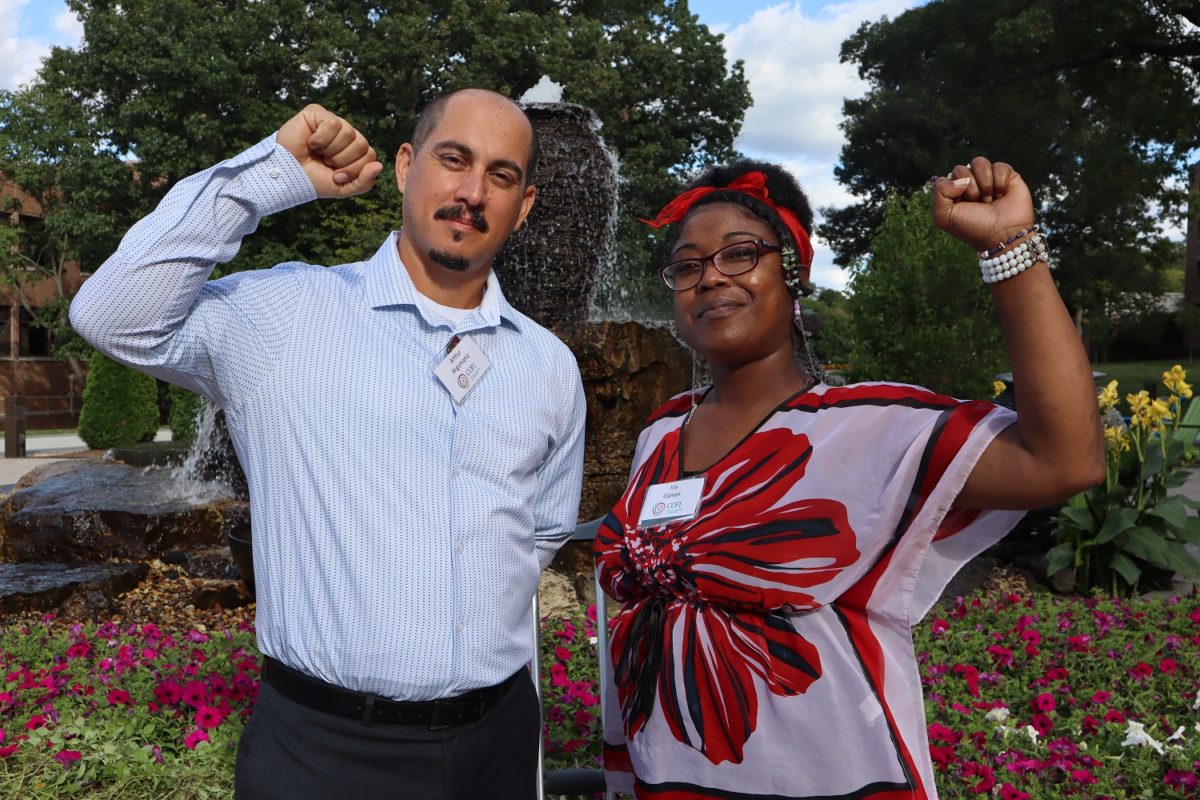 A man and woman raise their fists in the air