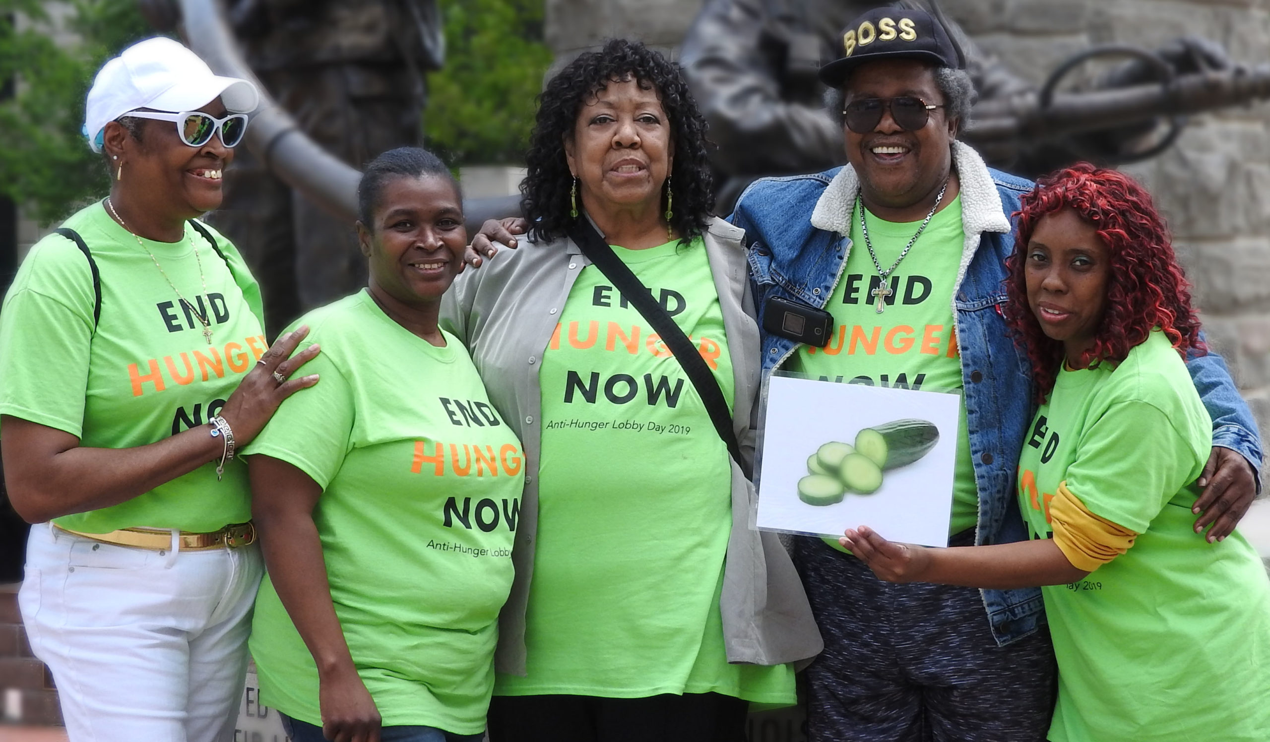Five women wearing matching green End Hunger Now shirts pose for a photo