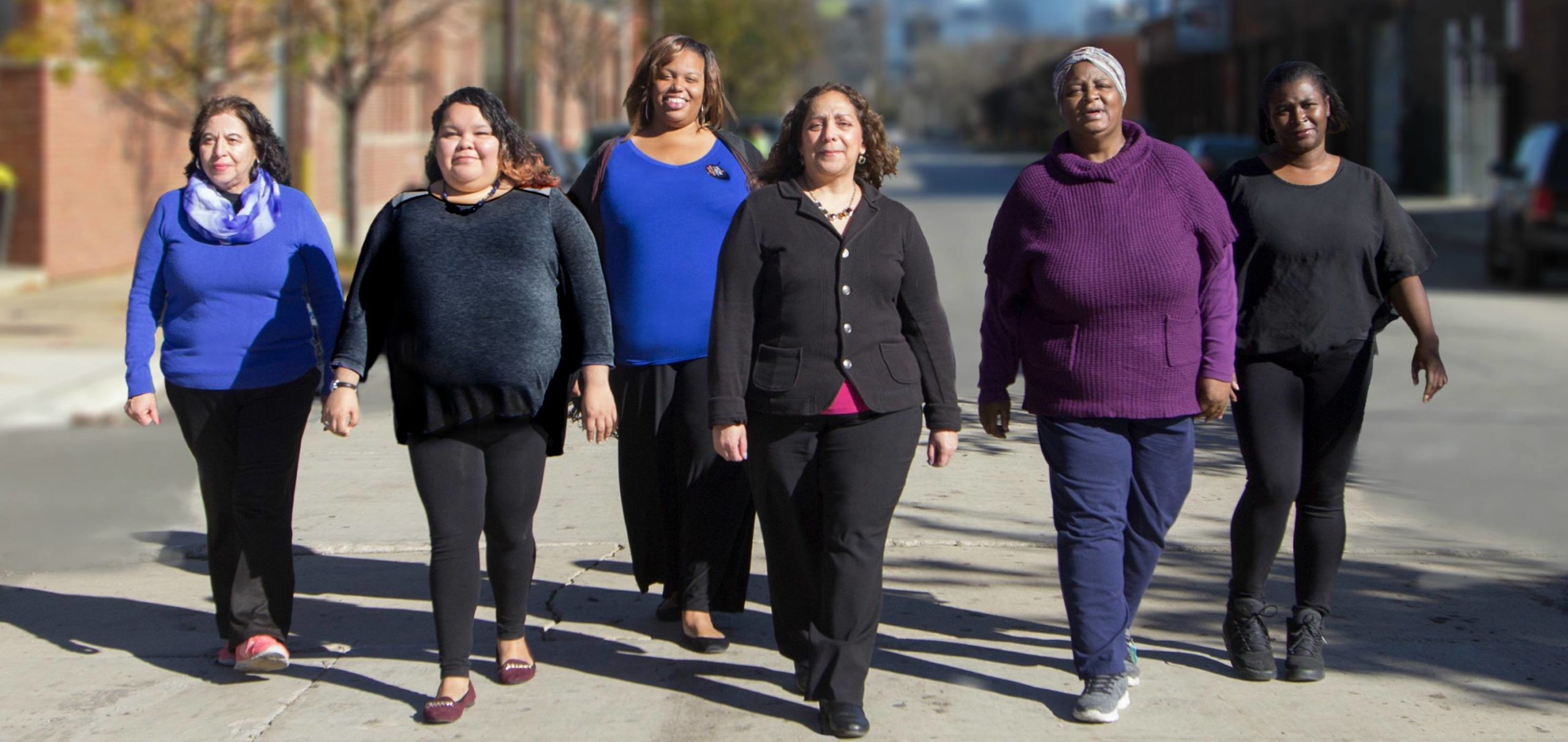 A group of powerful, confident women stride towards the camera