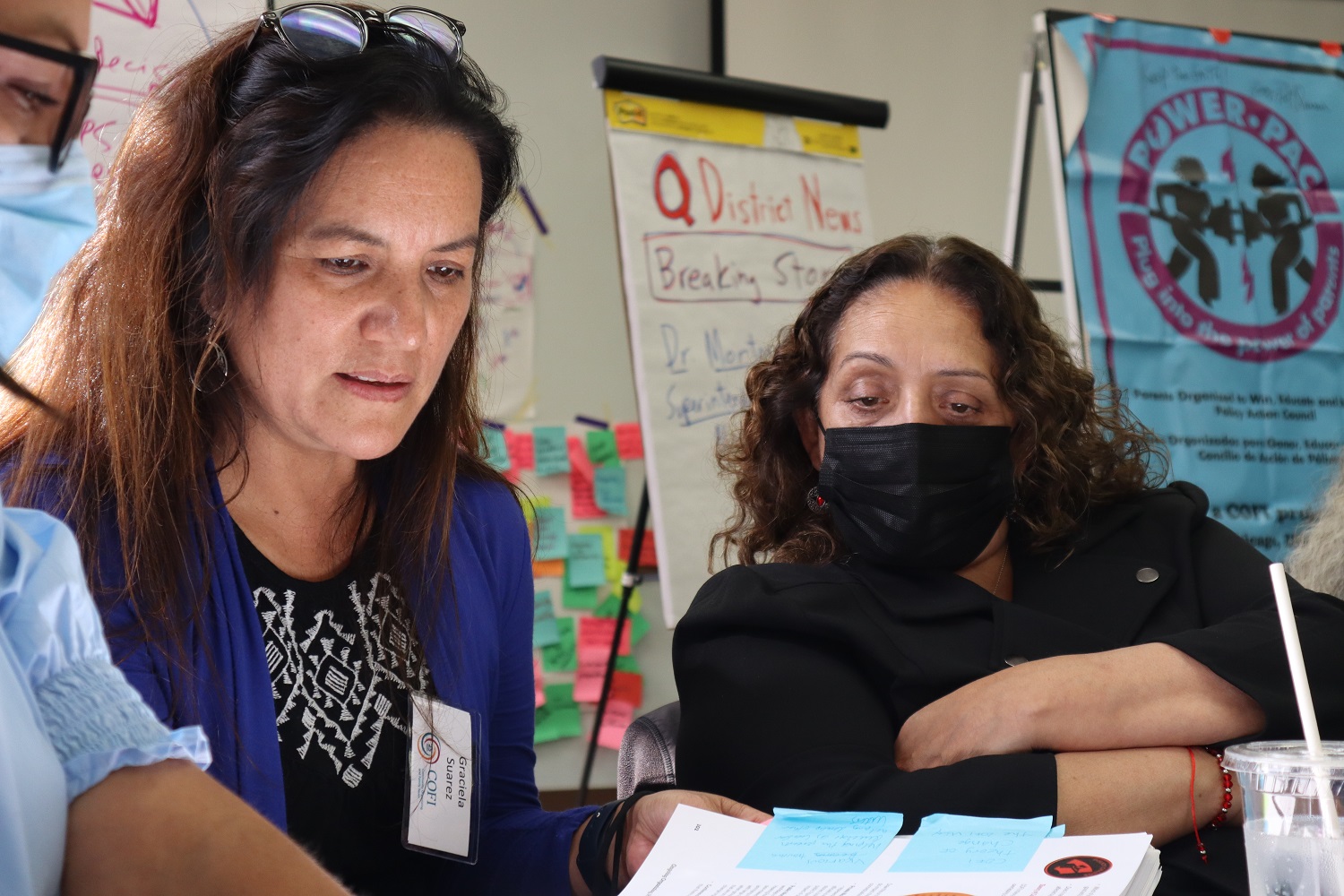 Two women are reviewing materials