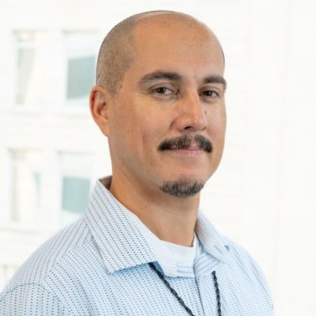 A headshot of a hispanic man