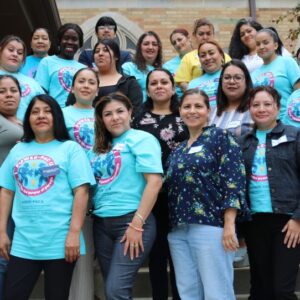 A group picture from the Aurora town hall. There are about 22 women and one man standing on a few rows of stairs