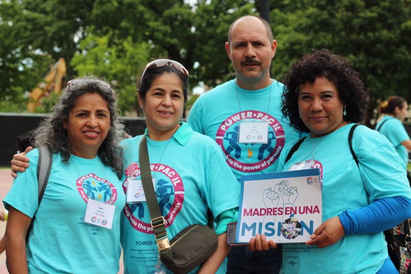 Four adults pose for a group photo