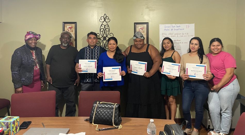 A picture from Fairmont City with six women and two men. Five people are holding certificates.