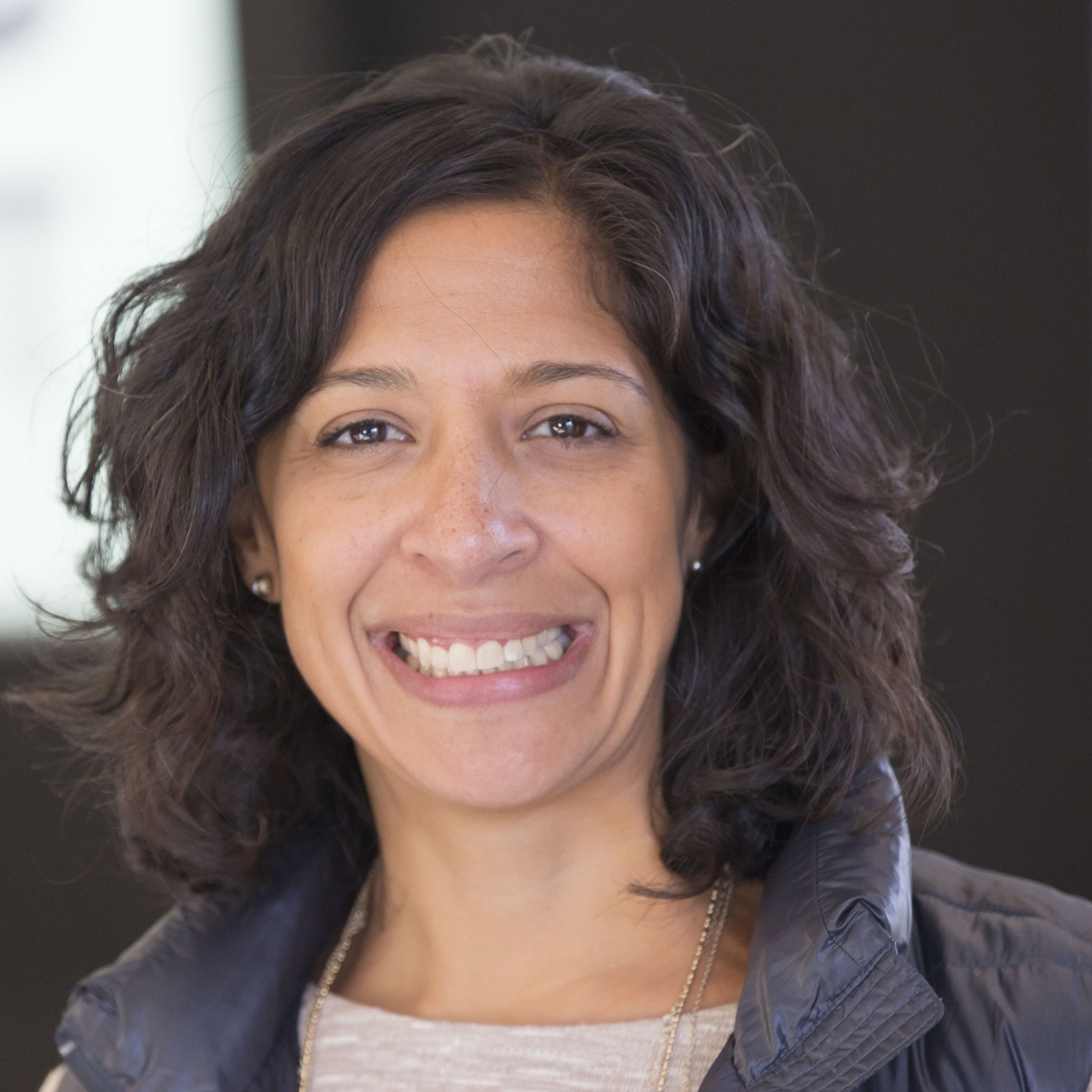 A headshot of a woman smiling