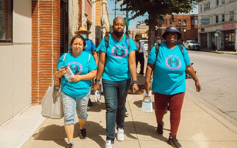 A photo featuring three women who are ambassadors and sharing information with the community